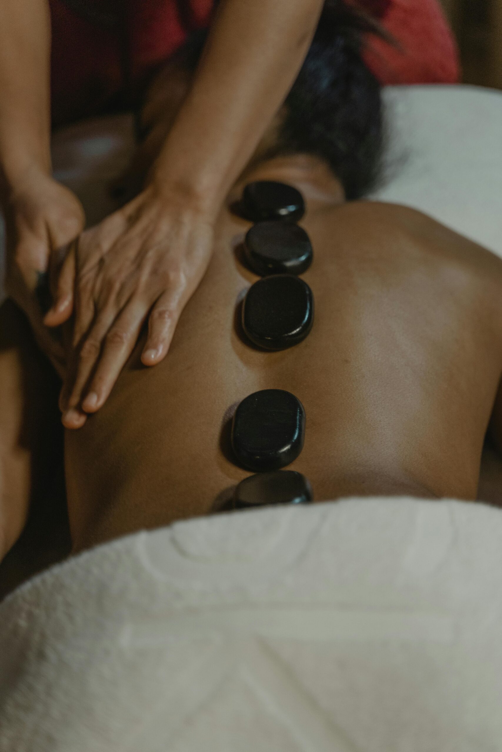 A soothing hot stone massage session offering relaxation and stress relief in a serene setting.